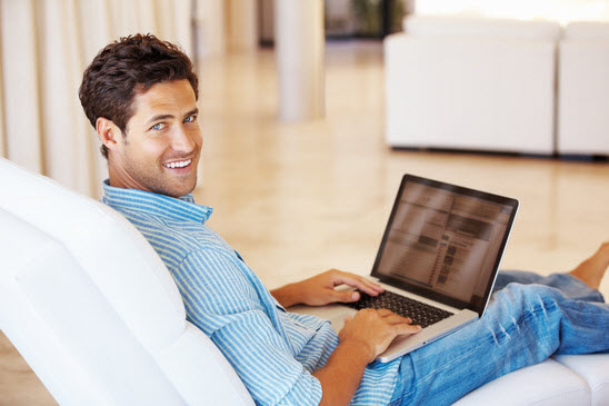 man-surfing-internet-on-laptop-and-smiling-xs